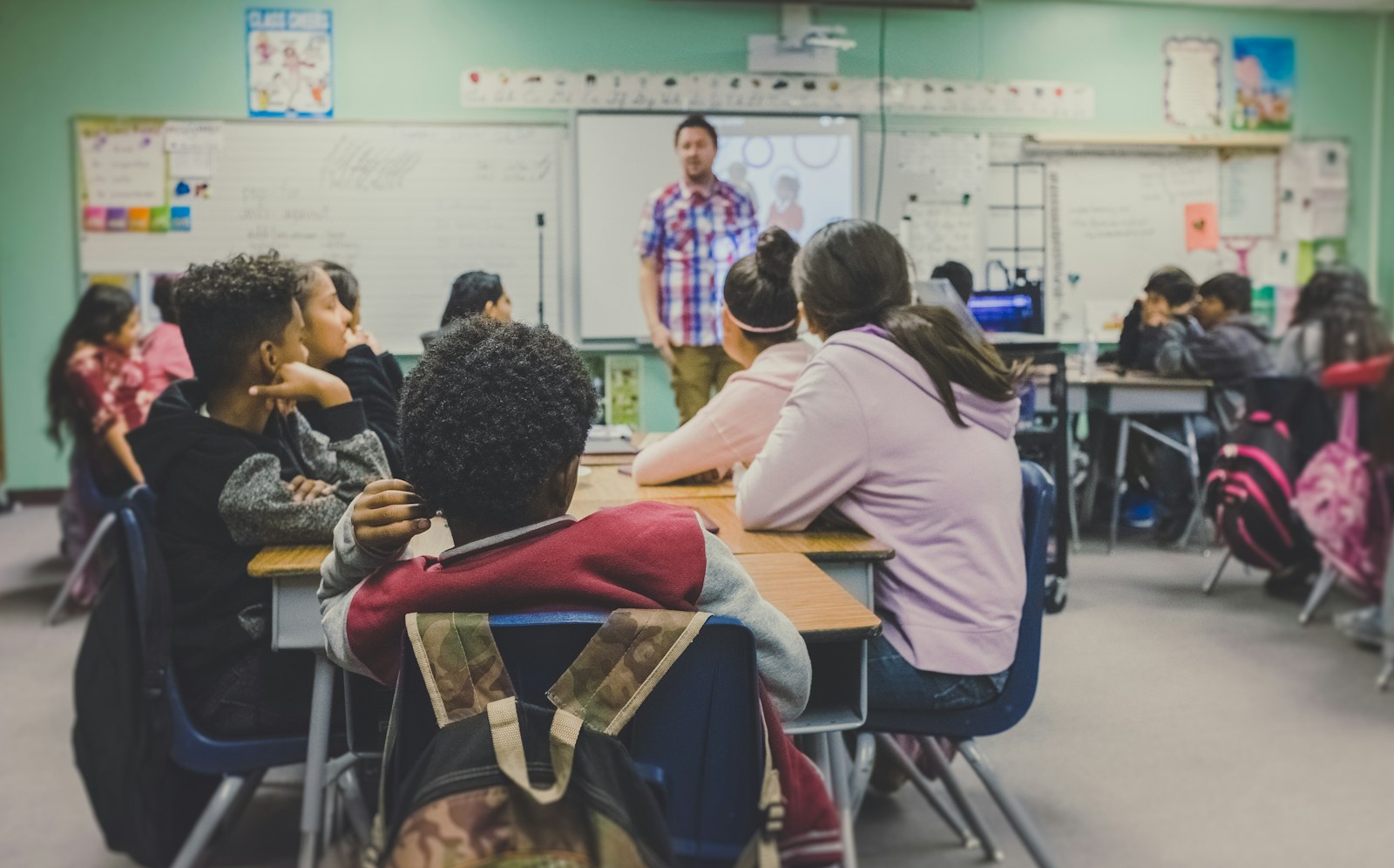 Teacher and students working together in a classroom